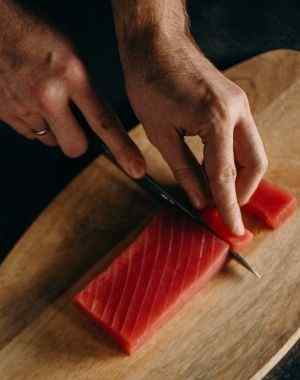 cutting raw tuna steaks